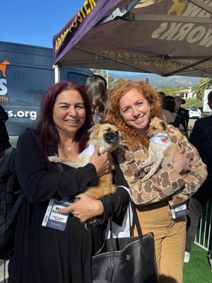 Attendees with puppies at Eventeny's FestForums sponsor activation